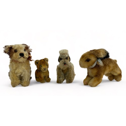 254 - Four vintage animal figures, believed to be Steiff. Includes a sitting tiger cub, a rabbit with a bl... 