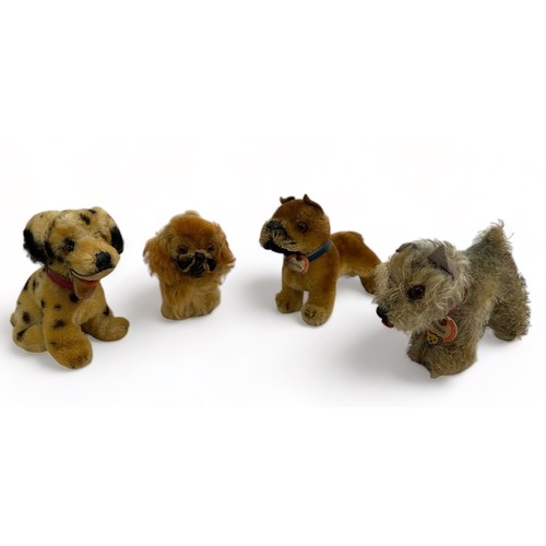 255 - Four vintage Steiff dogs. 'Tessie' with ID tag, unjointed with grey mohair fur (13cm length). A Peki... 