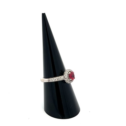 6 - A 14ct white gold ruby and diamond cluster ring, size M/N.  Ruby estimated at 0.6ct, estimated diamo... 