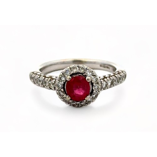 6 - A 14ct white gold ruby and diamond cluster ring, size M/N.  Ruby estimated at 0.6ct, estimated diamo... 