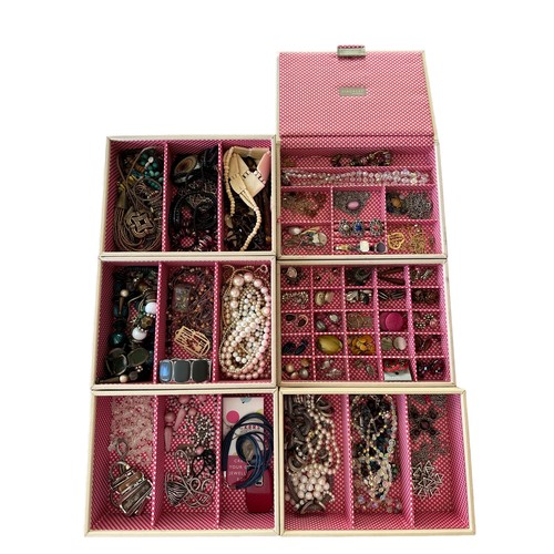 54 - A pastel coloured Stackers six section jewellery box containing a large amount of costume jewellery.... 