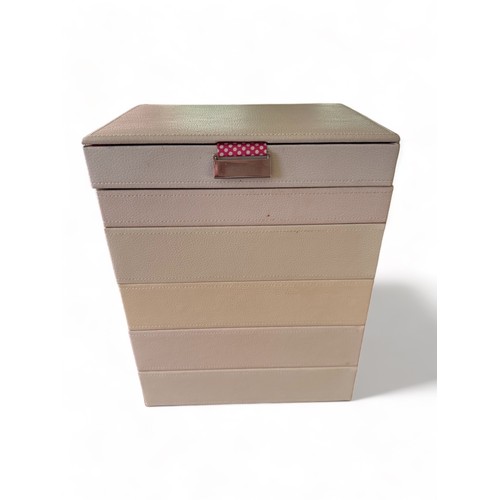 54 - A pastel coloured Stackers six section jewellery box containing a large amount of costume jewellery.... 