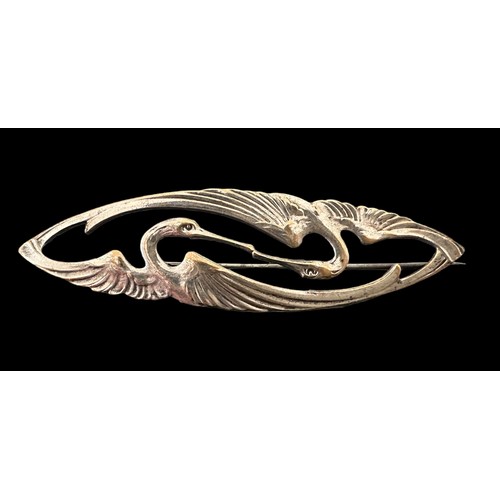 14 - An unmarked Art Nouveau style white metal brooch depicting two cranes. 7.5cm in length.

Please see ... 