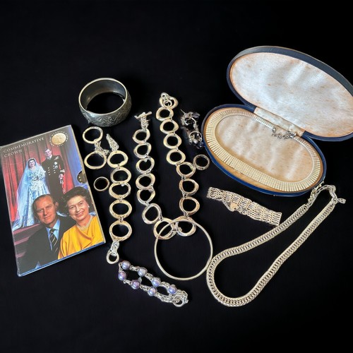 45 - A selection of silver and white metal jewellery. Includes a gate link bracelet, a silver and purple ... 