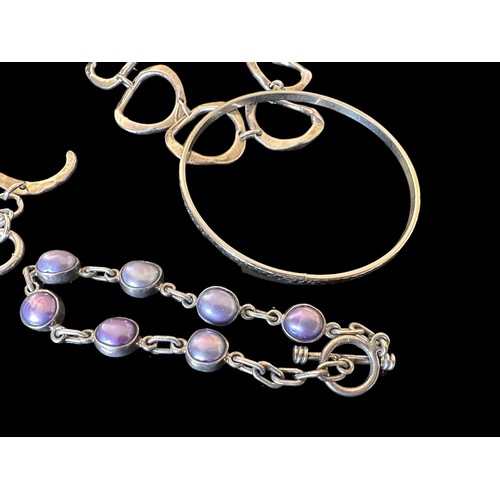 45 - A selection of silver and white metal jewellery. Includes a gate link bracelet, a silver and purple ... 