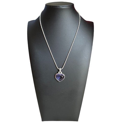 49 - A Swarovski crystal heart-shaped pendant with a purplish-blue hue on a Swarovski chain together with... 