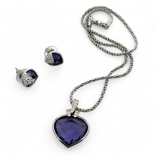 49 - A Swarovski crystal heart-shaped pendant with a purplish-blue hue on a Swarovski chain together with... 