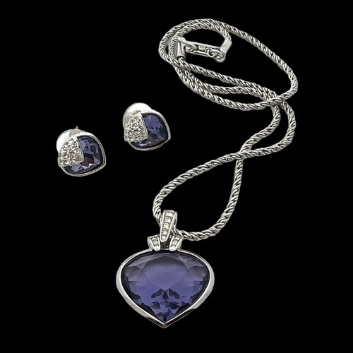 49 - A Swarovski crystal heart-shaped pendant with a purplish-blue hue on a Swarovski chain together with... 