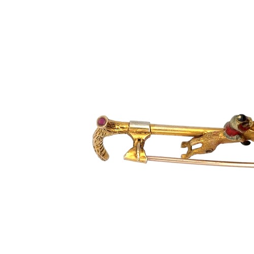 15 - A 9ct gold bar brooch in the form of a riding crop with a gold and enamel horse and jockey. Set with... 