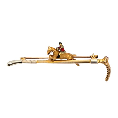 15 - A 9ct gold bar brooch in the form of a riding crop with a gold and enamel horse and jockey. Set with... 