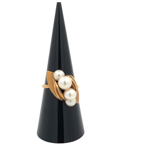 22 - A Mikimoto ring designed as a central crossover arch formed from four cultured pearls, set within ye... 