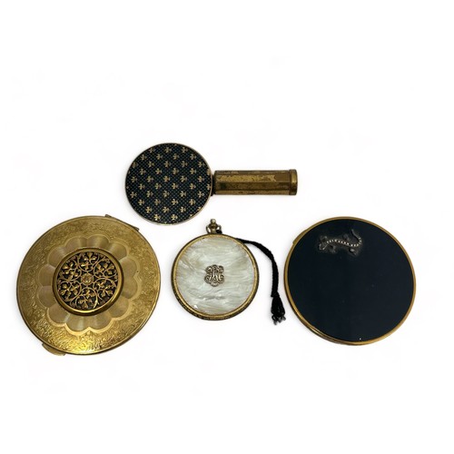 56 - Three powder compacts. Includes a Kigu compact, a Vogue compact with marcasite lizard decoration, a ... 