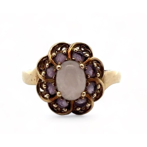 1 - An amethyst and white cabochon stone cluster ring, hallmarked 9ct gold. Size R.  Weight 3.58g.

Plea... 