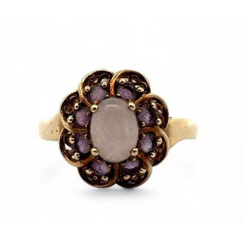 1 - An amethyst and white cabochon stone cluster ring, hallmarked 9ct gold. Size R.  Weight 3.58g.

Plea... 