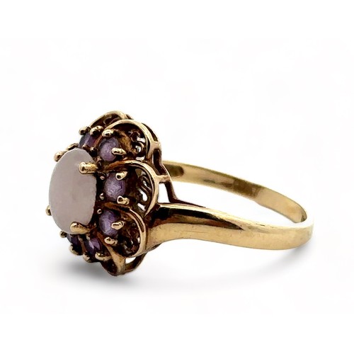 1 - An amethyst and white cabochon stone cluster ring, hallmarked 9ct gold. Size R.  Weight 3.58g.

Plea... 