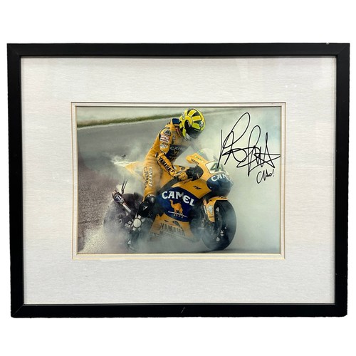 417 - Framed signed picture of Valentino Rossi doing a burnout on his Yamaha motorbike. No COA. Frame dime... 