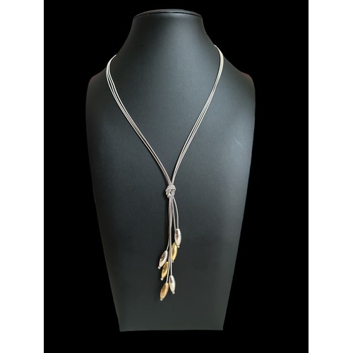 51 - A silver bi-coloured drop necklace. The necklace with a silver chain stamped 925, from which three s... 