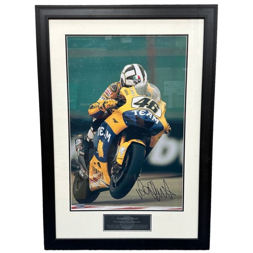 416 - Framed signed Valentino Rossi picture. Valentino Rossi on his yellow Yamaha motorbike, this image is... 