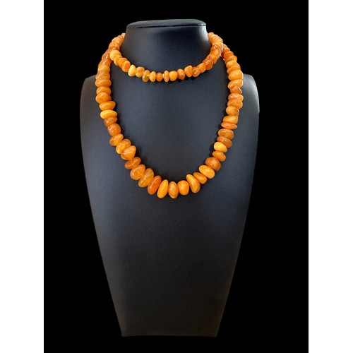 30 - A butterscotch amber necklace, approx 24inches in length.

Please see the buyer's terms and conditio... 