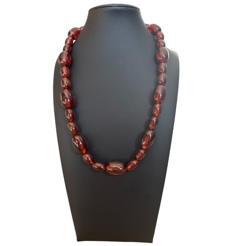 32 - A pressed amber bead necklace made up of a sequence of different sized amber beads. Approx 21 inches... 