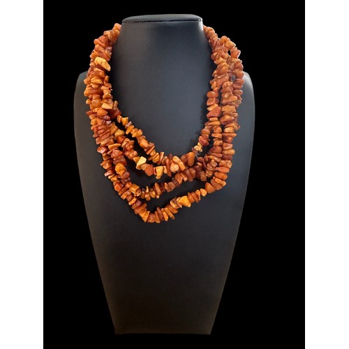 20 - A large amber necklace made from freeform pieces of amber.  Approx 72 inches in length.

Please see ... 