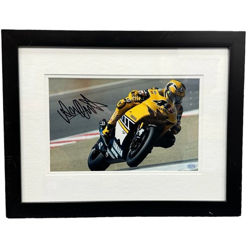 423 - Framed signed Valentino Rossi picture. Rossi pictured cornering on his yellow Yamaha motorbike. COA ... 