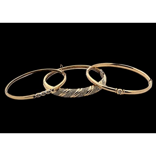 13 - Three 9ct gold and diamond bangles. 

Please see the buyer's terms and conditions for purchasing dia... 