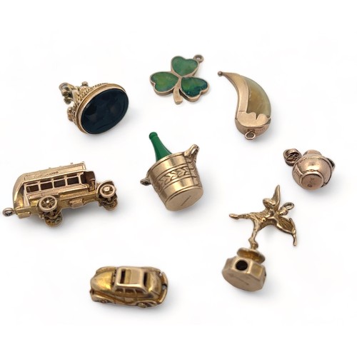 46 - A range of eight gold charms, six fully hallmarked, two (talon and bottle) stamped 9ct.  Total weigh... 