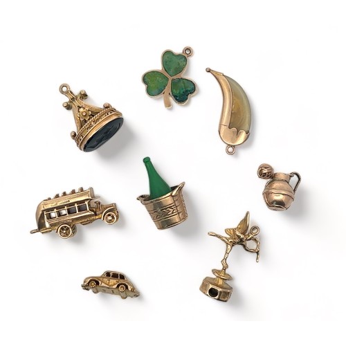 46 - A range of eight gold charms, six fully hallmarked, two (talon and bottle) stamped 9ct.  Total weigh... 