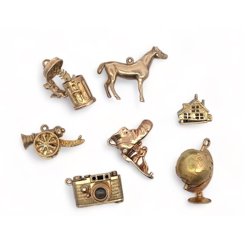 48 - A range of seven charms, five fully hallmarked 9ct gold, two (globe and cannon unmarked). Also inclu... 