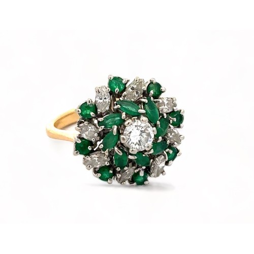 38 - An 18ct and platinum emerald and diamond cluster ring. The principal diamond estimated at 0.36ct is ... 