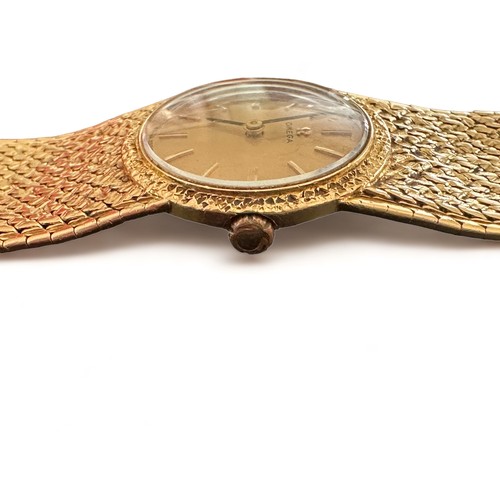 72 - Omega - A ladies Omega 18ct gold watch with hallmarked 18ct gold bracelet. Gold toned dial with bato... 