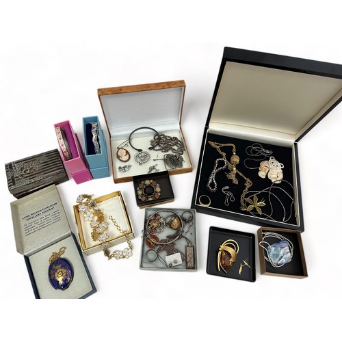 53 - A range of silver and costume jewellery items. Includes a hallmarked ingot pendant, teddy bear neckl... 