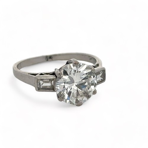 37 - A diamond solitaire ring, estimated 2.32ct with baguette diamond shoulders. Diamond is lively. Size ... 