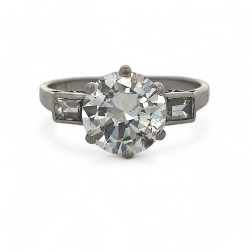 37 - A diamond solitaire ring, estimated 2.32ct with baguette diamond shoulders. Diamond is lively. Size ... 