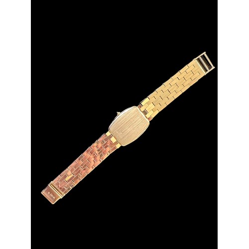 74A - Geneve, a 14k gold wristwatch, gold coloured rectangular dial with gold coloured batons and hands, c... 