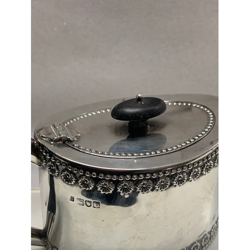 107 - A silver bachelor's teapot of straight sided oval form, ebonised wood handle and finial.  Fordham & ... 