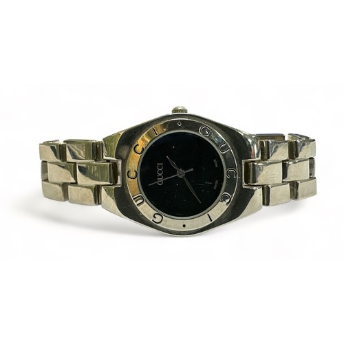 130 - A Gucci ladies wristwatch with black dial and stainless steel Gucci bracelet, af.