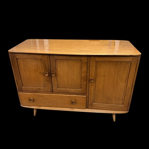 429 - An Ercol model 366 Windsor elm sideboard, fitted with a double door cupboard, a single drawer and a ... 