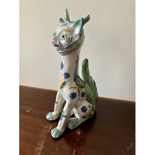 254 - Faience, Mosanic seated horned French ceramic cat, white with green and blue patterns including peac... 