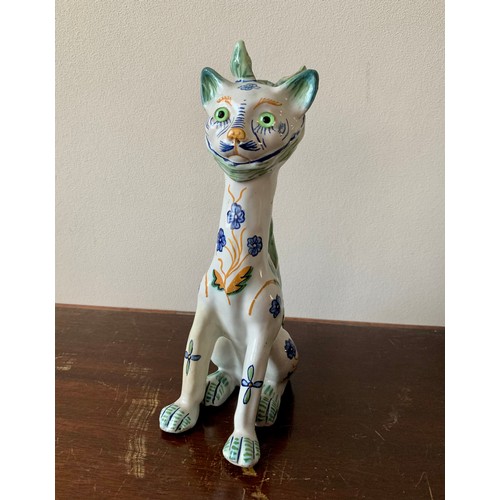 254 - Faience, Mosanic seated horned French ceramic cat, white with green and blue patterns including peac... 