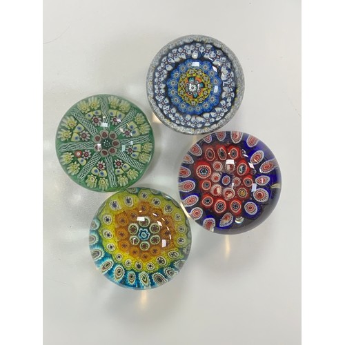 283 - Four vintage glass paperweights to include; Strathearn, millefiori designs. Diameters from 7cm to 8c... 