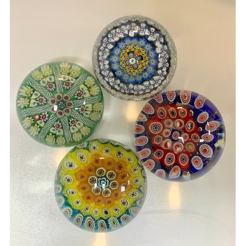 283 - Four vintage glass paperweights to include; Strathearn, millefiori designs. Diameters from 7cm to 8c... 