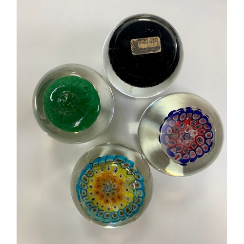 283 - Four vintage glass paperweights to include; Strathearn, millefiori designs. Diameters from 7cm to 8c... 