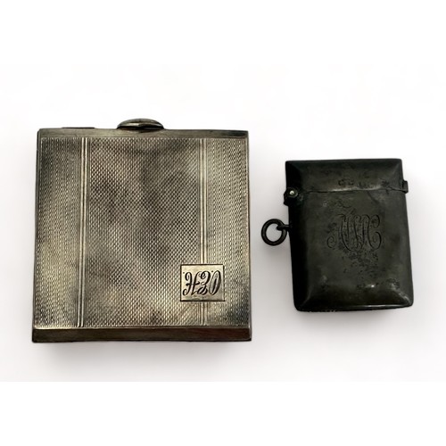 163 - A silver compact and silver vesta case.  Silver compact with engine turned decoration and monogram t... 