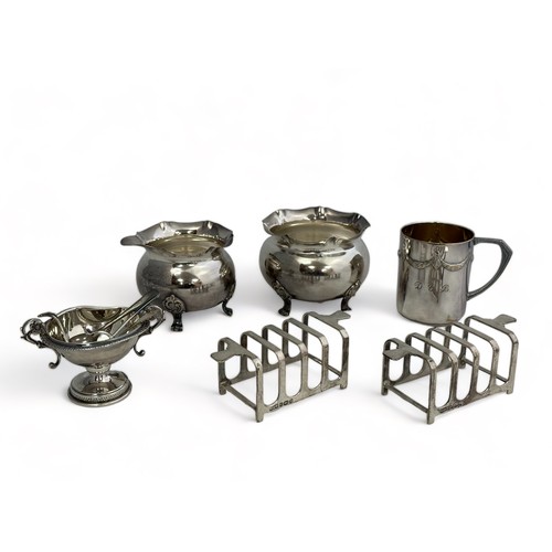 167 - A selection of silver and white metal items. Includes a pair of hallmarked four piece toast racks by... 