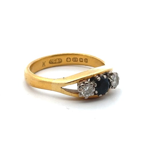 35 - A 22ct gold, sapphire and diamond ring, size R. Central sapphire of approx 4.2mm diameter is flanked... 