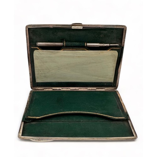 170 - A Victorian silver card case. Front embossed with a pastoral scene. Green fabric lined interior with... 