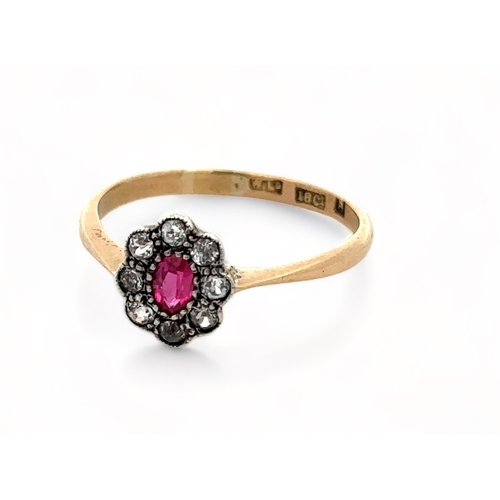 46 - A ruby and diamond cluster ring, set in 18ct yellow gold. Size O.  Weight 2.03g.