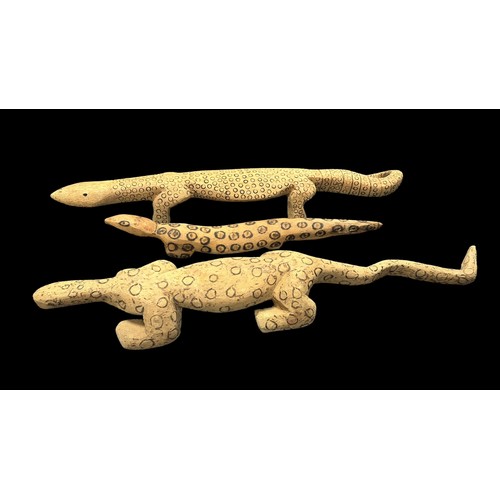 322 - Three Aboriginal Carved Lizards possibly representing Goanna's, monitor lizards, one 87 x 15cm cover... 